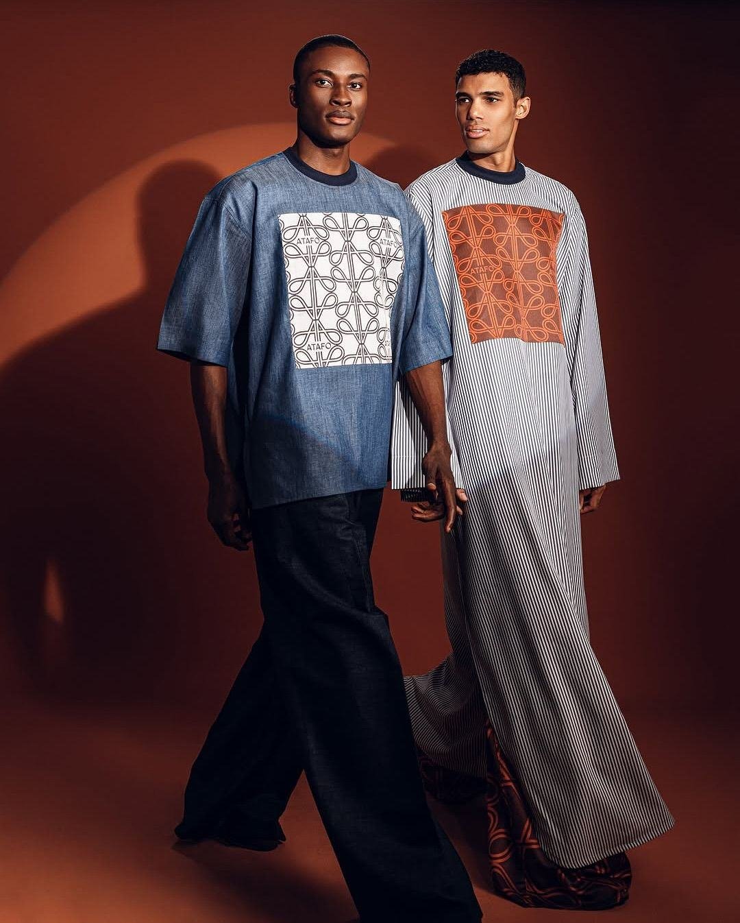 Two men wearing indigo and earth-toned heritage patterns